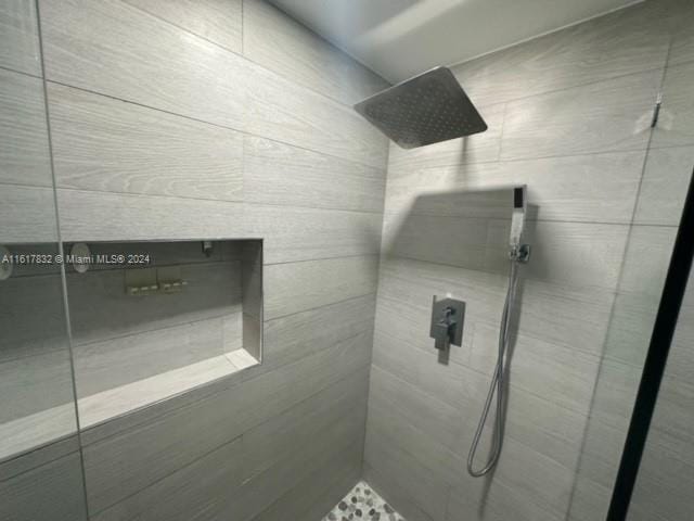 bathroom with tiled shower