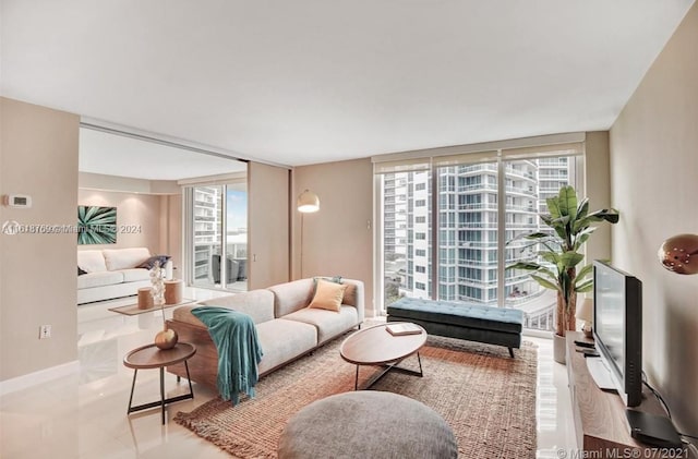 tiled living room with floor to ceiling windows