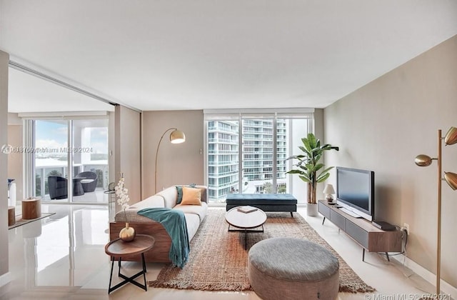 living room featuring light tile patterned floors and expansive windows