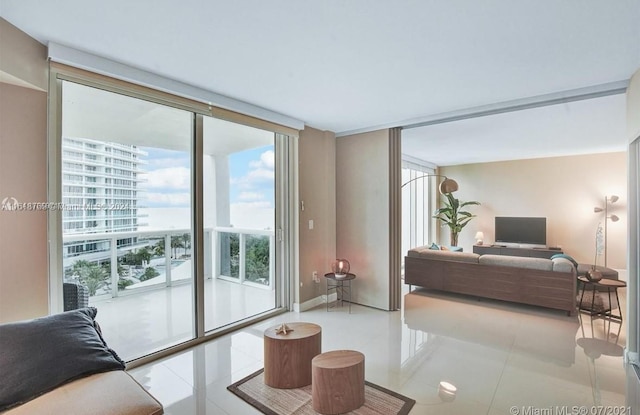 living room featuring light tile patterned flooring and floor to ceiling windows