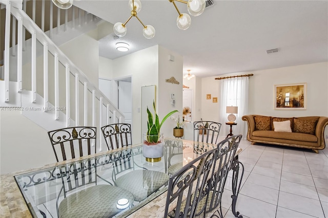 tiled dining space with an inviting chandelier