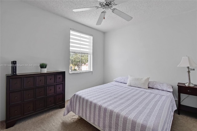 carpeted bedroom with a textured ceiling and ceiling fan