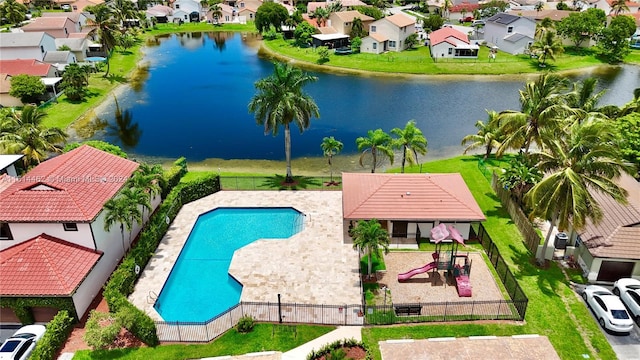 view of pool featuring a playground and a water view