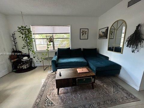 tiled living room with a textured ceiling