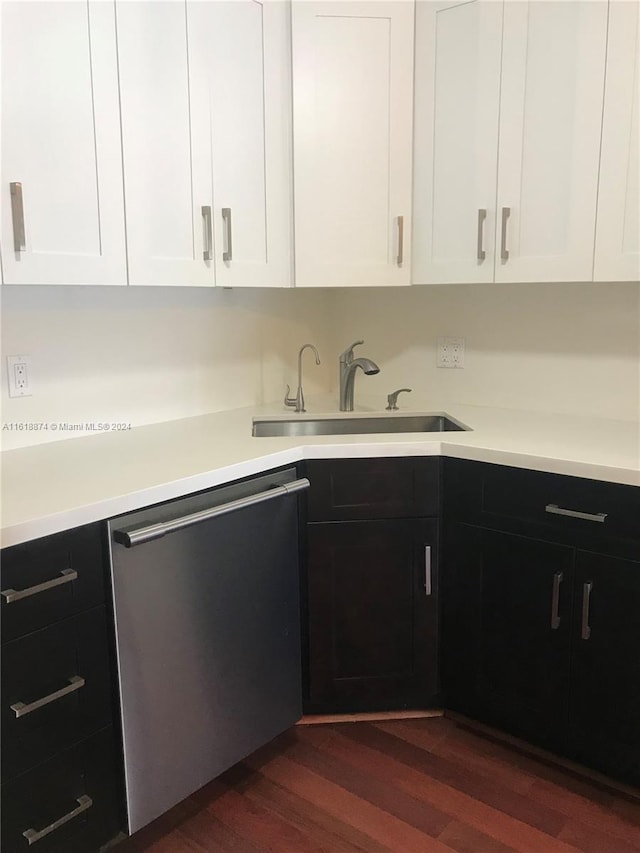 kitchen featuring white cabinetry, dark hardwood / wood-style floors, sink, and stainless steel dishwasher