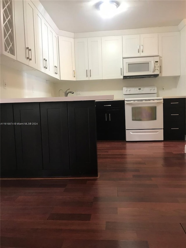 kitchen with dark hardwood / wood-style flooring, white cabinets, and white appliances