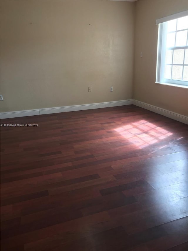 spare room featuring dark hardwood / wood-style flooring