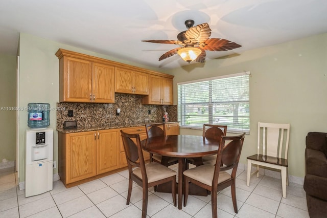 dining space with light tile patterned floors and ceiling fan