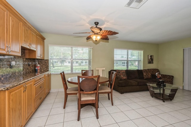 dining space featuring ceiling fan and light tile patterned floors