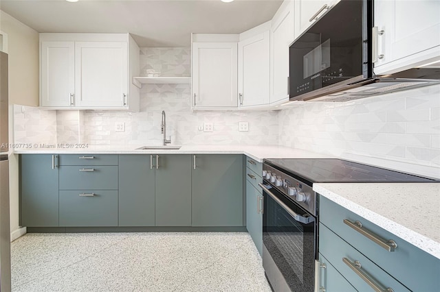 kitchen with black microwave, a sink, white cabinetry, and stainless steel range with electric cooktop