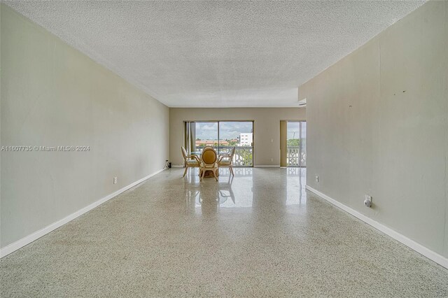 unfurnished room featuring a textured ceiling