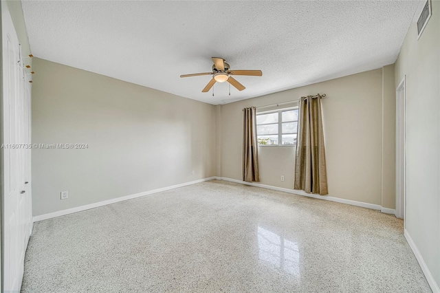 spare room featuring a textured ceiling and ceiling fan