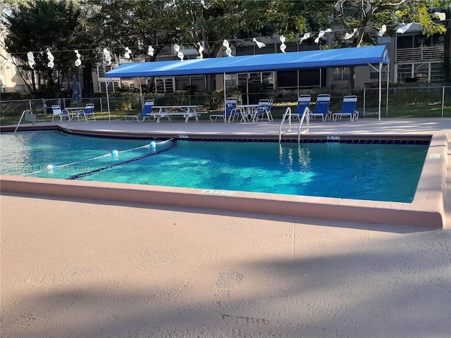 view of swimming pool with a patio