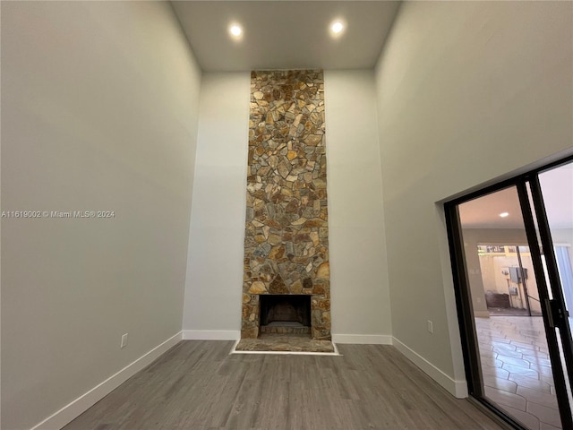 unfurnished living room with dark hardwood / wood-style floors and a fireplace