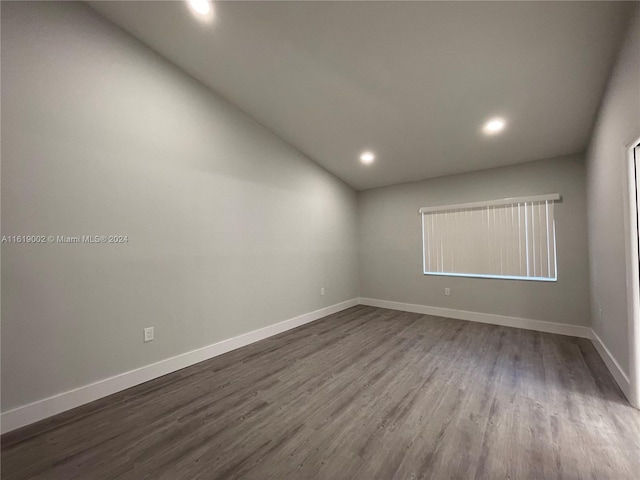 empty room featuring dark hardwood / wood-style flooring