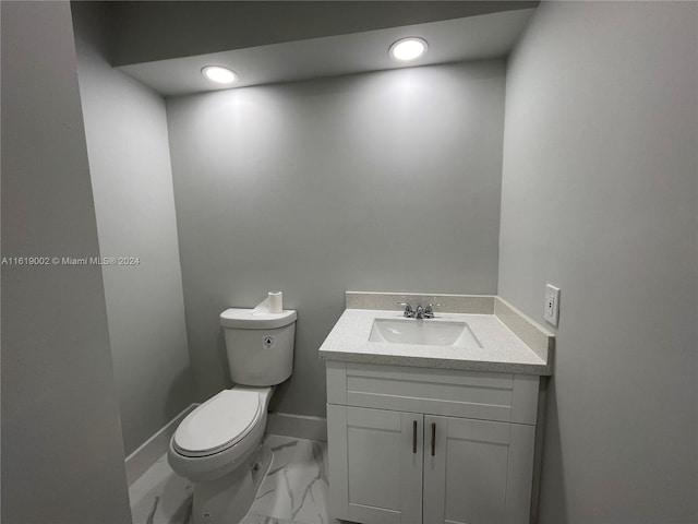 bathroom featuring tile patterned floors, vanity, and toilet