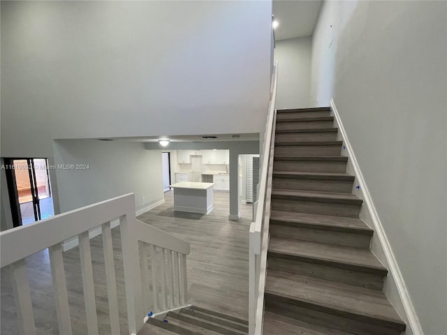 staircase with hardwood / wood-style flooring