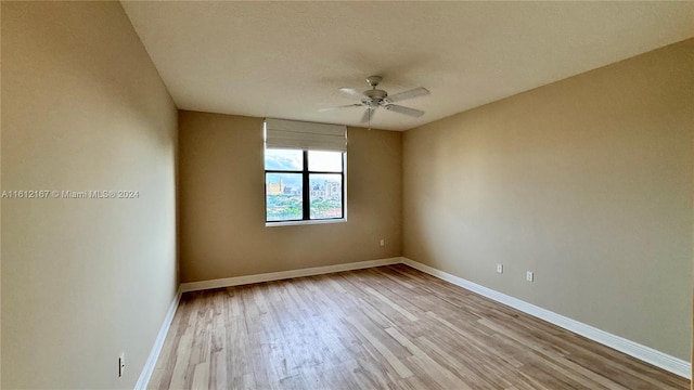 empty room featuring ceiling fan and light wood-type flooring