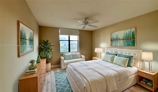 bedroom with light wood-type flooring and ceiling fan