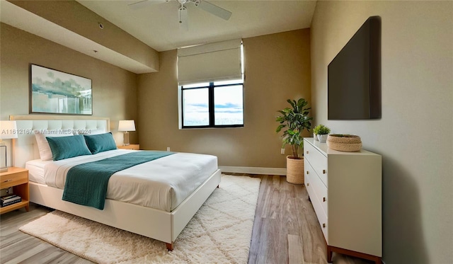 bedroom with light hardwood / wood-style floors and ceiling fan