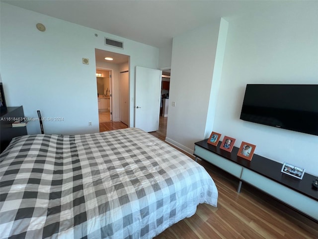 bedroom with hardwood / wood-style flooring