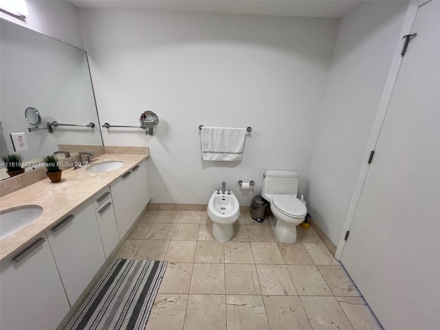 bathroom featuring vanity, toilet, and a bidet