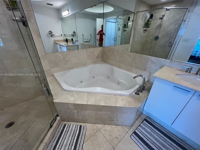 bathroom featuring separate shower and tub and vanity