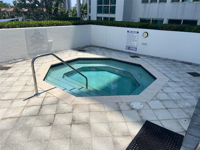 view of swimming pool featuring a community hot tub