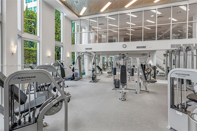 exercise room with a high ceiling and wood ceiling