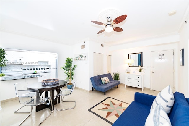 living room with ceiling fan, light tile patterned flooring, and ornamental molding