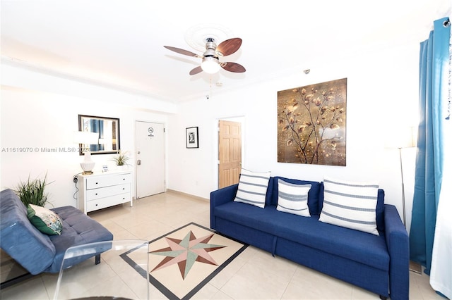 tiled living room with ceiling fan and ornamental molding