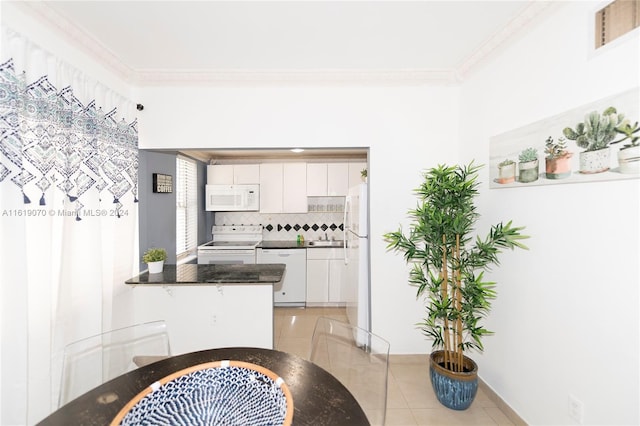 kitchen with decorative backsplash, white appliances, crown molding, light tile patterned floors, and white cabinetry