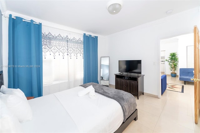 bedroom featuring light tile patterned floors and crown molding