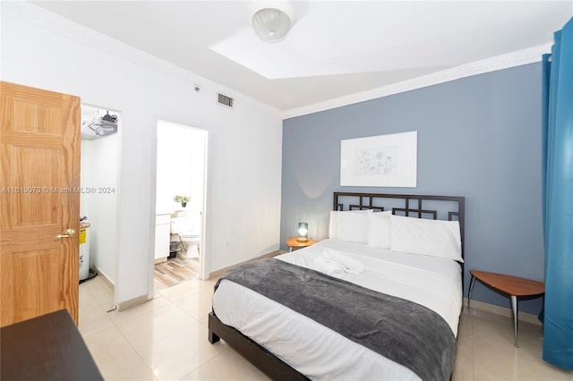 bedroom featuring ensuite bath, crown molding, and light tile patterned flooring