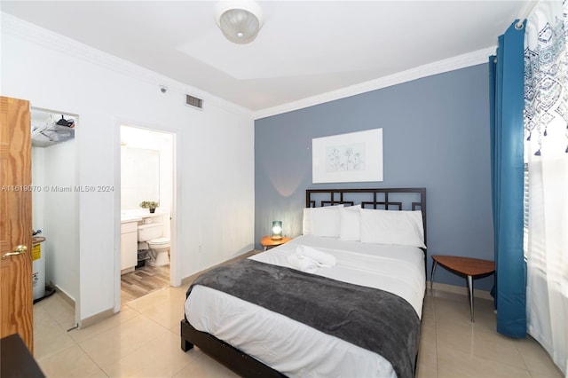 bedroom with ensuite bath, crown molding, and light tile patterned flooring