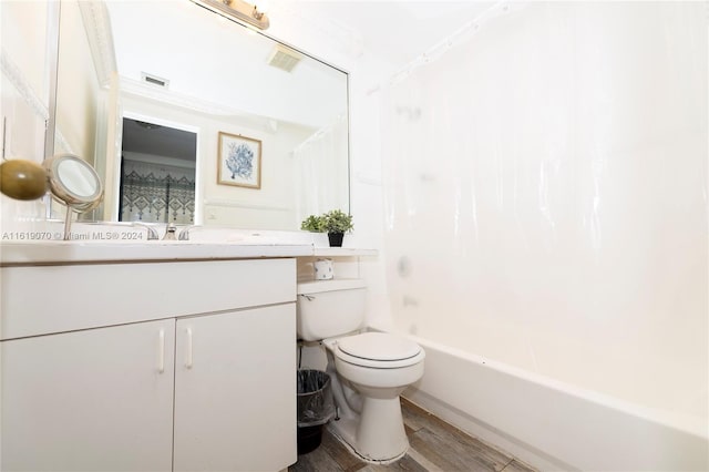 full bathroom with vanity, wood-type flooring, shower / tub combo, and toilet