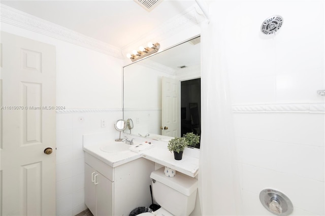 bathroom with vanity, toilet, and crown molding