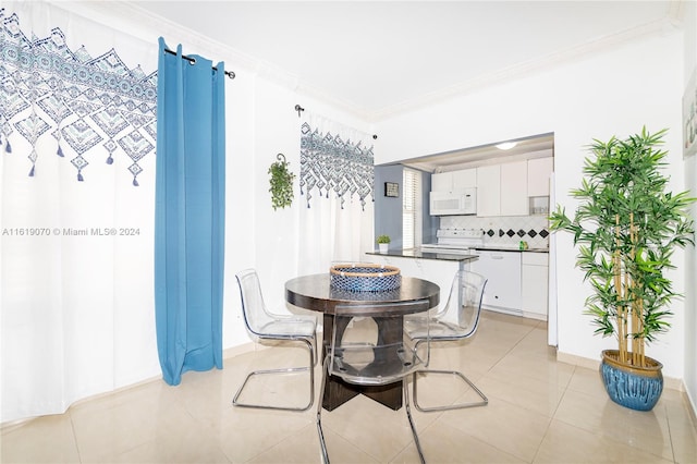 tiled dining room with ornamental molding