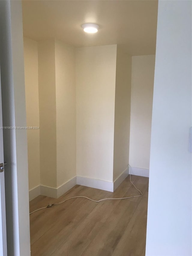 unfurnished room with hardwood / wood-style flooring