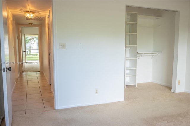 interior space with a closet and light colored carpet