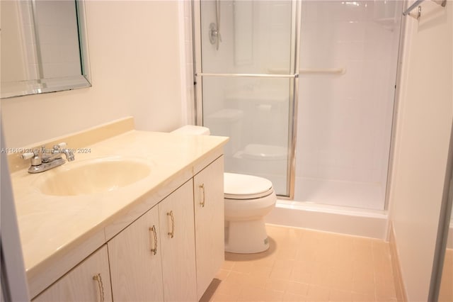 bathroom with vanity, toilet, walk in shower, and tile patterned floors