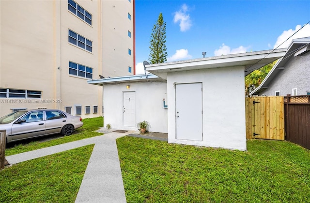 rear view of property featuring a yard