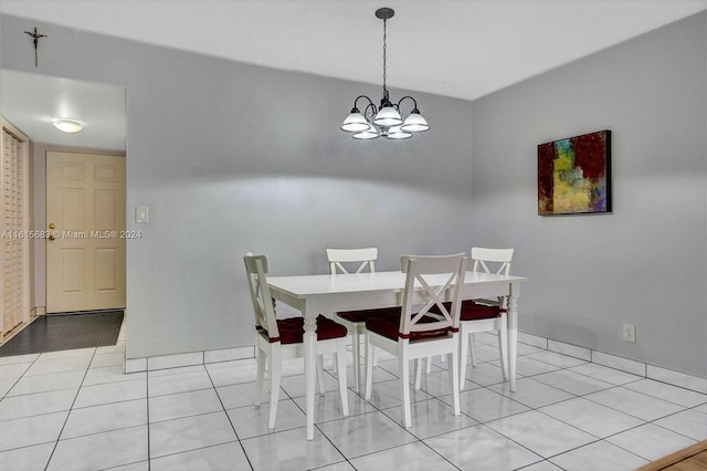 tiled dining space featuring a chandelier