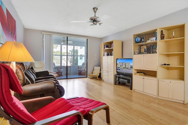 living room with light wood-type flooring and ceiling fan