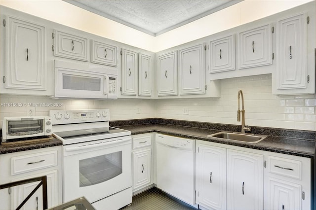 kitchen with decorative backsplash, white appliances, sink, and white cabinets