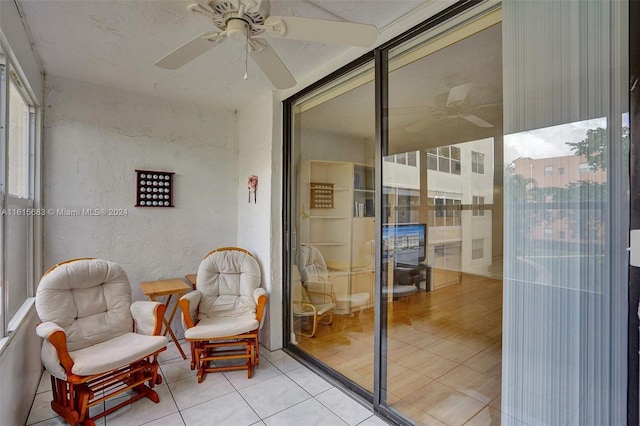 sunroom featuring ceiling fan