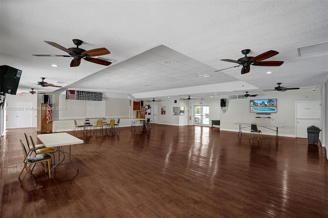 interior space with wood-type flooring, a textured ceiling, and ceiling fan