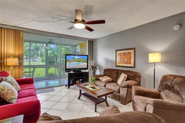 tiled living room with ceiling fan, a textured ceiling, and floor to ceiling windows