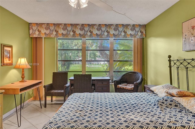 tiled bedroom featuring a textured ceiling and ceiling fan