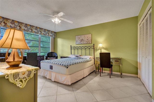 bedroom with a textured ceiling, a closet, and ceiling fan